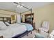 Bright main bedroom featuring carpet floors, a four-poster bed, and sitting area with a window view at 842 Amidon St, Deltona, FL 32725