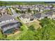 Aerial view of a house in a lakeside community with a backyard, screened in pool, and lush landscaping at 8420 Corkfield Ave, Orlando, FL 32832