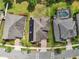 Aerial view of home featuring a well manicured lawn, brick driveway, solar panels, and a screened in pool in the backyard at 8420 Corkfield Ave, Orlando, FL 32832