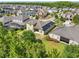 An aerial view of the back of the house, well manicured lawn, solar panels, and gorgeous landscaping with mature trees at 8420 Corkfield Ave, Orlando, FL 32832