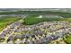 Beautiful community from an aerial view, surrounded by a dense treeline, with a pond nearby at 8420 Corkfield Ave, Orlando, FL 32832