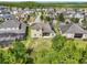 An aerial view of the back of the house, a well manicured lawn, and a gorgeous neighborhood near a lake at 8420 Corkfield Ave, Orlando, FL 32832
