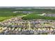 Serene aerial neighborhood view highlighting well-maintained homes, lush trees, and serene ponds at 8420 Corkfield Ave, Orlando, FL 32832