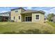 Back exterior of the home with a patio and a view of the green backyard at 8420 Corkfield Ave, Orlando, FL 32832