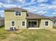 Home's backyard showing the lawn, patio, the home's exterior, and cooling systems at 8420 Corkfield Ave, Orlando, FL 32832