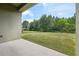 View of the expansive backyard with lush green lawn and mature trees at 8420 Corkfield Ave, Orlando, FL 32832
