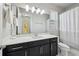 Bright bathroom featuring a wide mirror, granite countertop, and tiled floor at 8420 Corkfield Ave, Orlando, FL 32832
