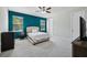 Cozy bedroom with blue accent wall, soft carpet, and windows at 8420 Corkfield Ave, Orlando, FL 32832