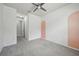 Empty bedroom with gray carpet, a ceiling fan, and two peach colored arches at 8420 Corkfield Ave, Orlando, FL 32832
