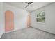 Empty bedroom with gray carpet, a ceiling fan, and unique design touches at 8420 Corkfield Ave, Orlando, FL 32832