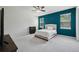 Cozy bedroom with blue accent wall and a carpet floor at 8420 Corkfield Ave, Orlando, FL 32832