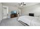 Primary bedroom featuring a TV, carpet floors, and access to an en-suite at 8420 Corkfield Ave, Orlando, FL 32832