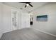 Spacious bedroom with gray carpet, a ceiling fan, and a walk-in closet at 8420 Corkfield Ave, Orlando, FL 32832