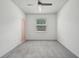 Empty bedroom with gray carpet, a ceiling fan, and a window at 8420 Corkfield Ave, Orlando, FL 32832
