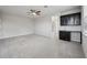 Large bonus room with gray carpet and a small bar with black cabinets at 8420 Corkfield Ave, Orlando, FL 32832