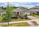 Lovely one story home boasts manicured lawn, tasteful landscaping, and covered front porch at 8420 Corkfield Ave, Orlando, FL 32832
