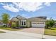 Charming single-Gathering home with a well-manicured lawn, beautiful landscaping, and a brick-paved driveway at 8420 Corkfield Ave, Orlando, FL 32832