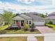 Beautiful single Gathering home featuring a brick driveway, a porch, and a well-kept lawn at 8420 Corkfield Ave, Orlando, FL 32832