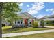 Beautiful single-Gathering home with a landscaped front yard and a welcoming porch with decorative columns at 8420 Corkfield Ave, Orlando, FL 32832
