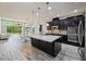 Open floor plan shows kitchen with stainless appliances and large island and eat in space at 8420 Corkfield Ave, Orlando, FL 32832