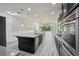 The modern kitchen boasts an island, stainless steel appliances, and an eat in space at 8420 Corkfield Ave, Orlando, FL 32832