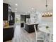 Modern kitchen features a center island, stainless steel appliances, and wood look flooring at 8420 Corkfield Ave, Orlando, FL 32832