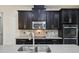 A detailed shot of the modern kitchen features stainless steel appliances and granite countertops at 8420 Corkfield Ave, Orlando, FL 32832