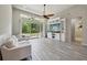 Bright living room with vaulted ceilings, a ceiling fan, large sliding glass doors, and stylish built-in shelving at 8420 Corkfield Ave, Orlando, FL 32832