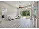 Bright living room with vaulted ceilings, a ceiling fan, large sliding glass doors, and stylish gray wood-look tile flooring at 8420 Corkfield Ave, Orlando, FL 32832