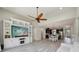 Open-concept living and kitchen area featuring gray wood-look tile flooring and vaulted ceilings at 8420 Corkfield Ave, Orlando, FL 32832