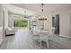 Bright living room with stylish gray wood-look tile flooring, vaulted ceilings, and natural light at 8420 Corkfield Ave, Orlando, FL 32832