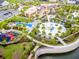 Stunning aerial view of the community resort-style pool, playground, and amenities at 8943 Coconut Breeze Dr, Kissimmee, FL 34747