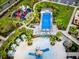 Wonderful aerial view featuring the community playground, tennis court, and splash pad at 8943 Coconut Breeze Dr, Kissimmee, FL 34747