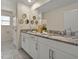 Bathroom featuring double vanity with granite countertops, decorative mirrors, and ample cabinet space at 8943 Coconut Breeze Dr, Kissimmee, FL 34747