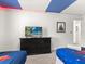 Themed bedroom with playful blue accents and a dresser featuring a flat screen TV at 8943 Coconut Breeze Dr, Kissimmee, FL 34747