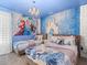 Themed bedroom with two twin beds, cartoon decor, and a decorative chandelier at 8943 Coconut Breeze Dr, Kissimmee, FL 34747