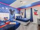 Whimsical bedroom with Mickey Mouse-themed decor and twin beds, perfect for  at 8943 Coconut Breeze Dr, Kissimmee, FL 34747