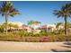 Beautiful community entrance with lush landscaping, mature palm trees, and a serene fountain at 8943 Coconut Breeze Dr, Kissimmee, FL 34747