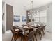 Dining area featuring modern chandelier, seating for eight, and contemporary decor at 8943 Coconut Breeze Dr, Kissimmee, FL 34747