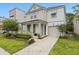 Charming two-story home with a welcoming front porch and landscaped front yard at 8943 Coconut Breeze Dr, Kissimmee, FL 34747