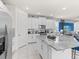 Modern kitchen with white cabinets, granite countertops, and stainless steel appliances, ideal for cooking and entertaining at 8943 Coconut Breeze Dr, Kissimmee, FL 34747