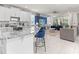 Stylish kitchen with a granite island, seating, and an open view to the living room, perfect for socializing at 8943 Coconut Breeze Dr, Kissimmee, FL 34747
