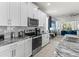 Modern kitchen with stainless steel appliances, granite countertops, and ample cabinet space at 8943 Coconut Breeze Dr, Kissimmee, FL 34747