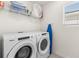 Neat laundry room features a Whirlpool washer and dryer with wire shelving at 8943 Coconut Breeze Dr, Kissimmee, FL 34747