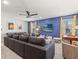 Recreation area with air hockey table, large sofa, wall-mounted TV and blue accent wall at 8943 Coconut Breeze Dr, Kissimmee, FL 34747