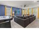Spacious living area featuring air hockey table, sofa, and a wall mounted TV at 8943 Coconut Breeze Dr, Kissimmee, FL 34747