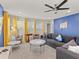 Open living area with ample seating, blue accent wall, and a ceiling fan at 8943 Coconut Breeze Dr, Kissimmee, FL 34747