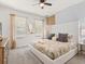 Bedroom with ceiling fan, large bed, and natural light from multiple windows at 8943 Coconut Breeze Dr, Kissimmee, FL 34747