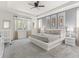 Spacious bedroom with tray ceiling, large windows, and a king-sized bed at 8943 Coconut Breeze Dr, Kissimmee, FL 34747