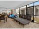 Enclosed patio featuring comfortable seating with tables and lounge chairs for relaxation at 8943 Coconut Breeze Dr, Kissimmee, FL 34747